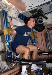 Astronaut Lee Archambault, commander of the STS-119 mission, conducts an Advanced Resistive Exercise Device (ARED) workout in the Unity node aboard the International Space Station. (NASA)