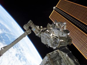 The International Space Station Canadarm (pictured here) led to a technology spinoff to assist with brain surgery on Earth. (NASA)