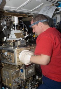 Expedition 23 Flight Engineer T.J. Creamer works to setup Light Microscopy Module (LMM) and Constrained Vapor Bubble (CVB) hardware in the Fluids Integrated Rack (FIR) in the Destiny U.S. Laboratory. (NASA)