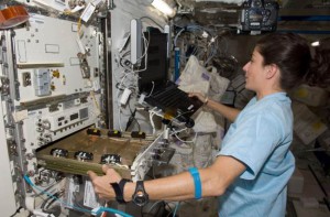 Astronaut Nicole Stott works with the high-density protein crystal growth (HDPCG) apparatus aboard the International Space Station. (NASA)