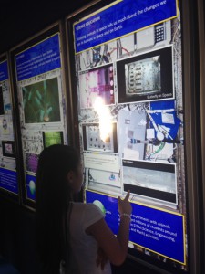 A young visitor to the NASA mobile exhibit interacts with a display of a research rack as it would appear aboard the International Space Station. (Tara Ruttley)