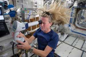 NASA astronaut Karen Nyberg, Expedition 36 flight engineer, conducts an ocular health exam on herself in the Destiny laboratory of the Earth-orbiting International Space Station. (NASA)