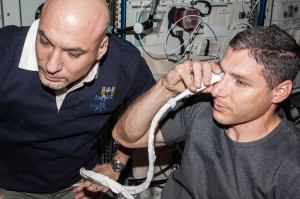 NASA astronaut Michael Hopkins and European Space Agency astronaut Luca Parmitano perform ultrasound eye imaging as part of the Fluid Shifts investigation during Expedition 37 on the International Space Station. (NASA)