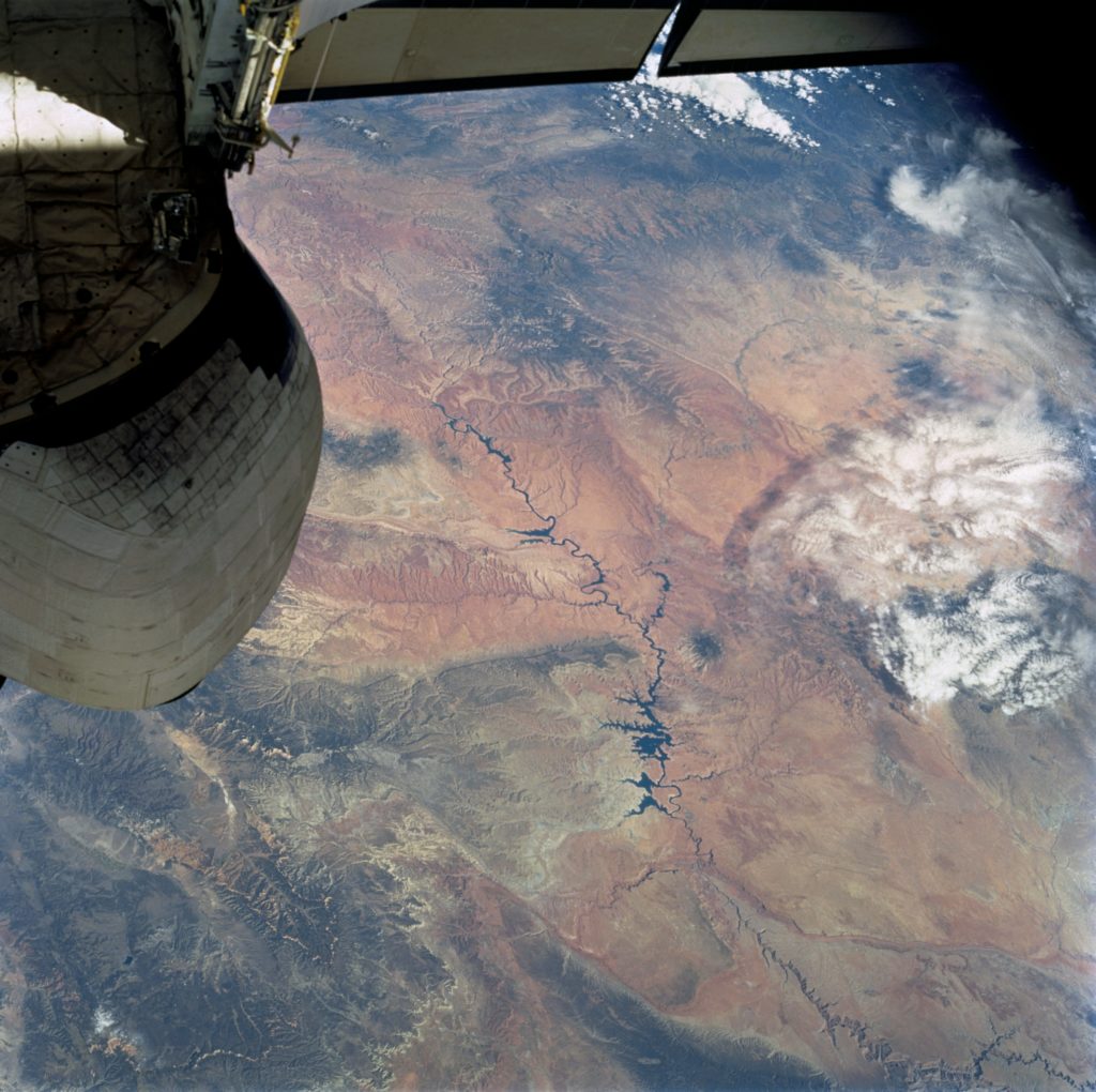 The Colorado River snakes across this view from top left (near the Space Shuttle stabilizer), to the lower right, where the Grand Canyon gorge can be detected. This image was captured on Oct. 13, 2002, during Sellers’ mission aboard STS-112. Credits: NASA