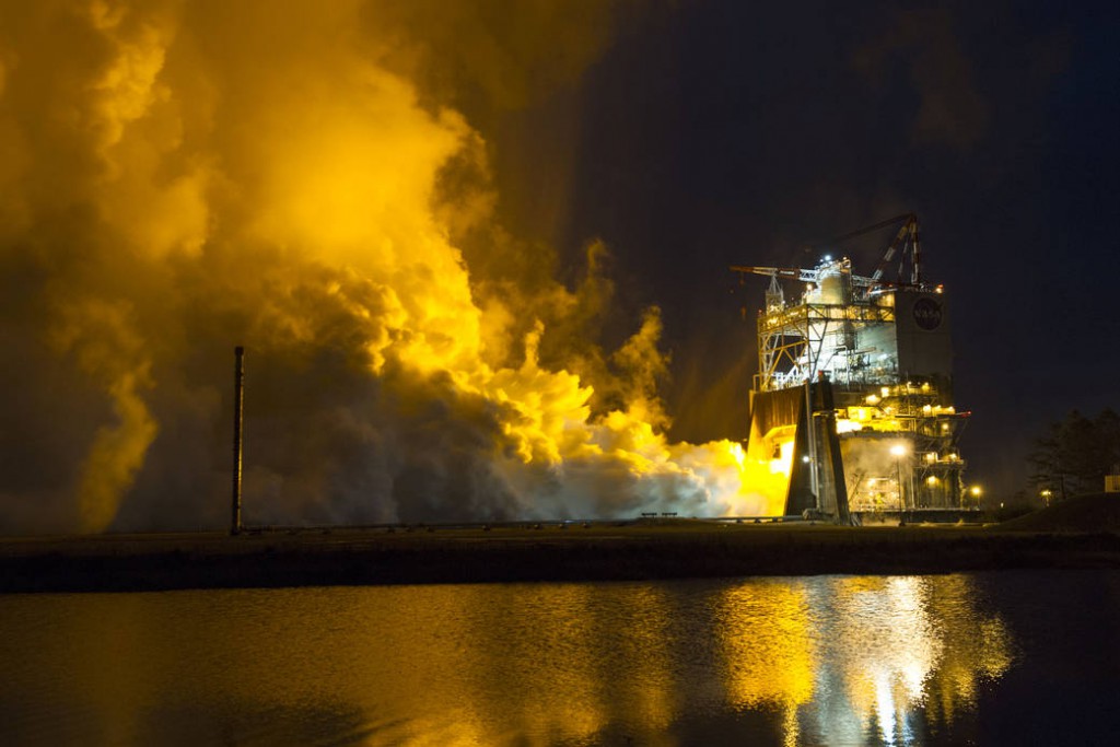 Fire streaming from a test stand during an RS-25 test