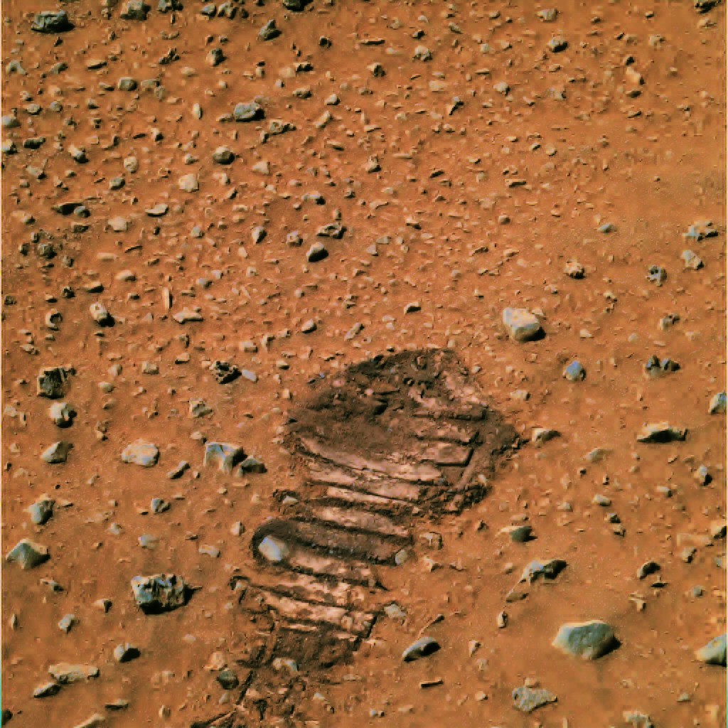 A photo of a rover wheel track on Mars that resembles a human footprint