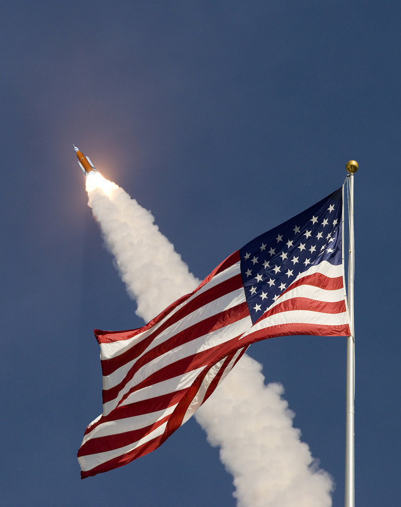 Artist concept of an American flag in front of an SLS launch