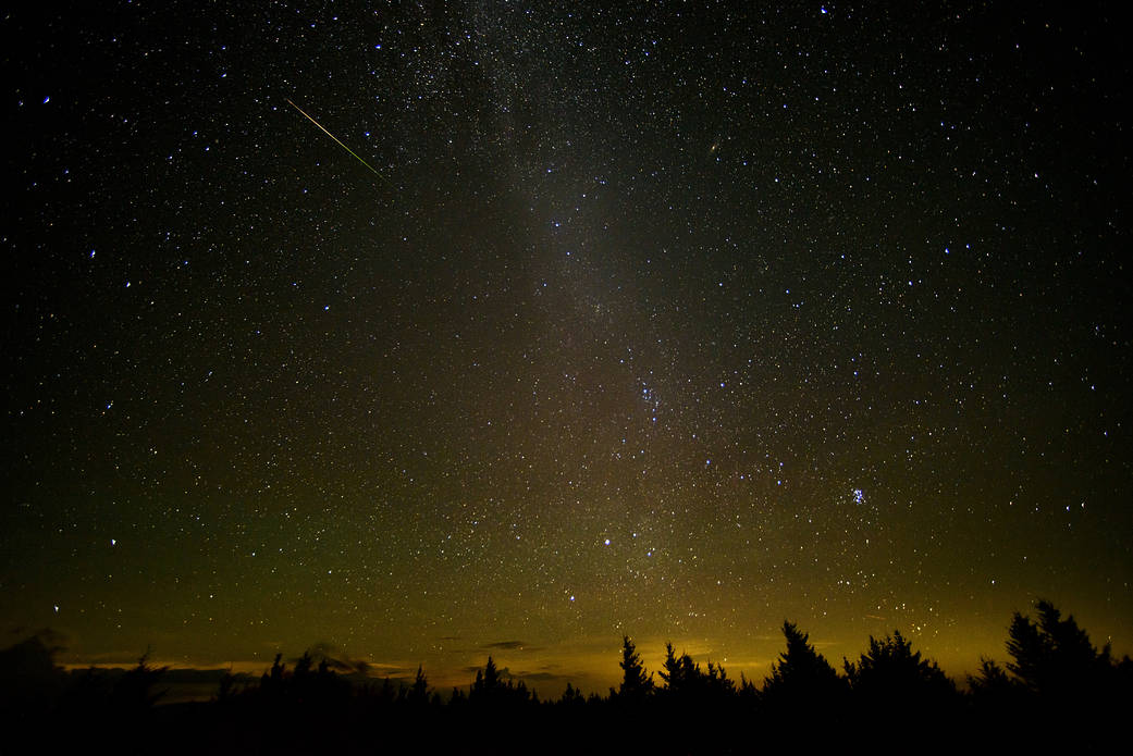 In this 30 second exposure, a meteor streaks across the sky during the annual Perseid meteor shower Friday, Aug. 12, 2016 in Spruce Knob, West Virginia. The Perseids show up every year in August when Earth ventures through trails of debris left behind by an ancient comet. Image 