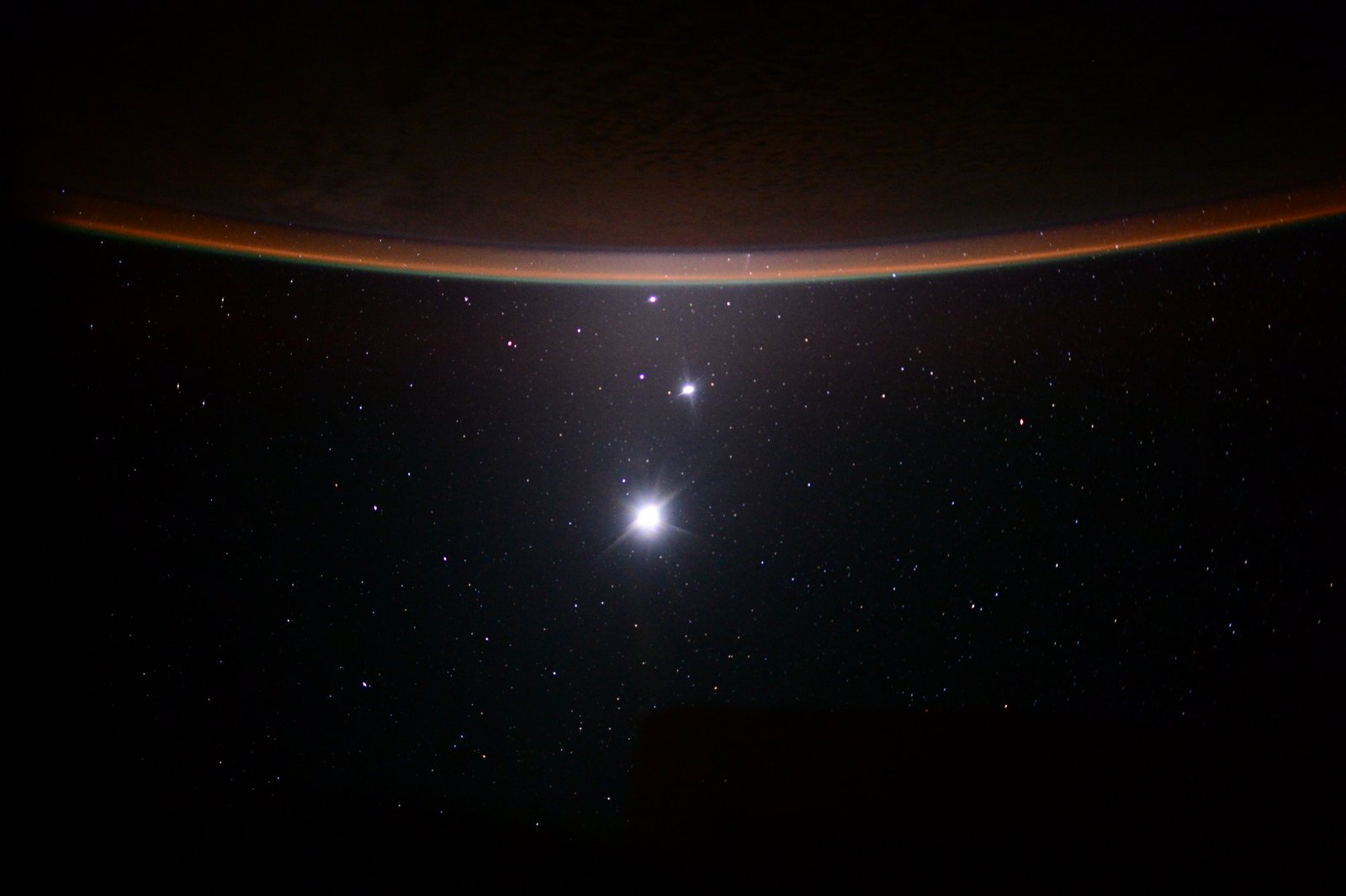 The image reveals Earth's Moon, Venus, Jupiter, and Earth's crescent, arranged from bottom to top.