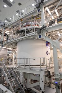 The NASA and ESA insignias are in view on the Orion spacecraft adapter jettison fairing inside the MPPF at Kennedy Space Center.