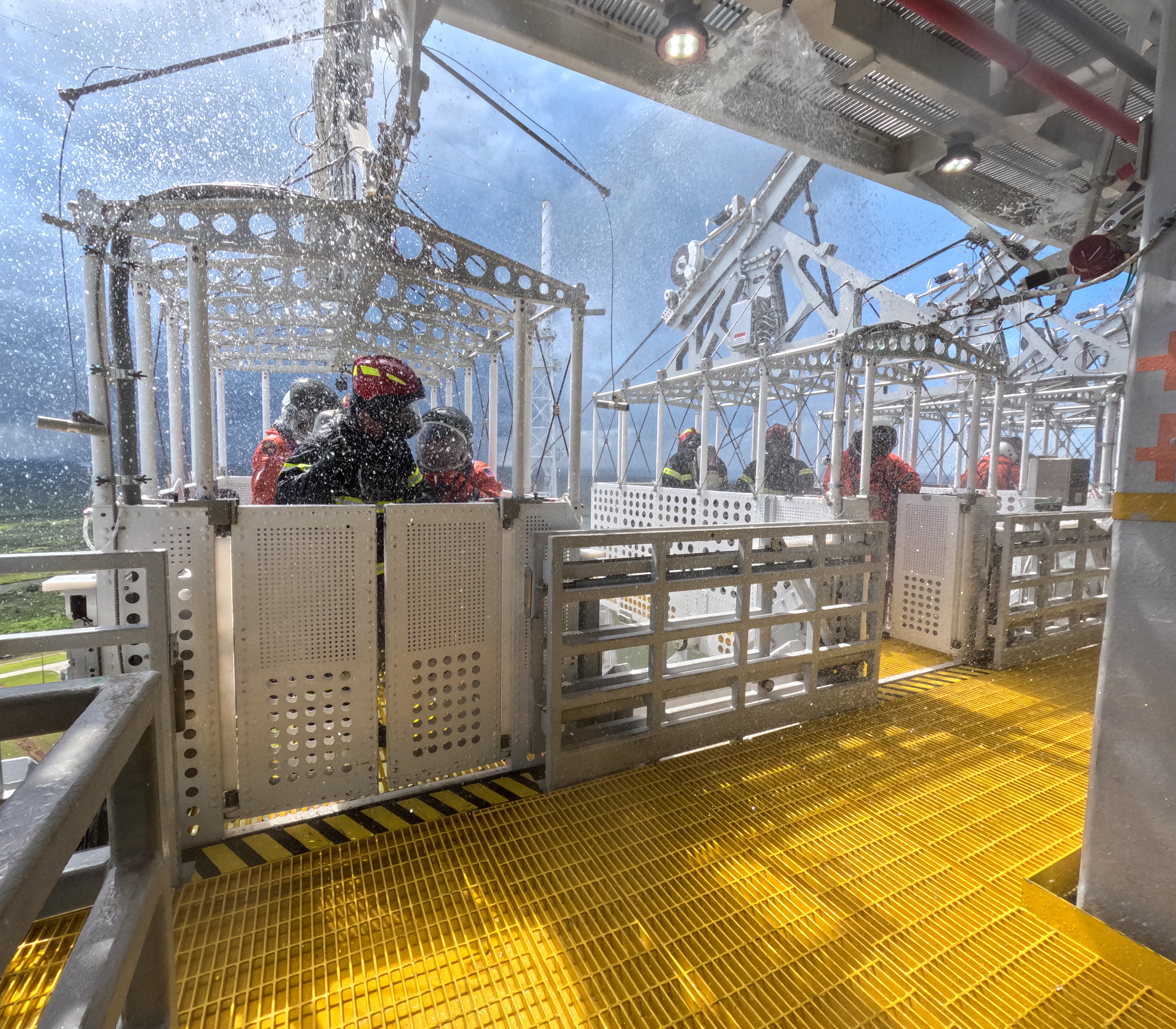 Teams at NASA's Kennedy Space Center in Florida are seen entering the Artemis emergency egress baskets on the mobile launcher 1 at Launch Pad 39B as part of a practice demonstration to learn the emergency escape or egress procedures ahead of the Artemis II launch.