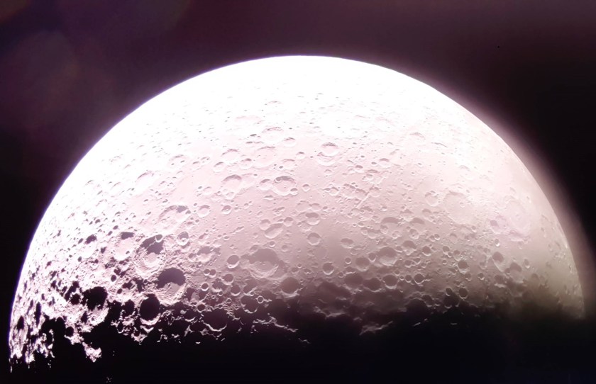 A bright Moon in the darkness of space with the Moon’s South Pole visible on the far left.