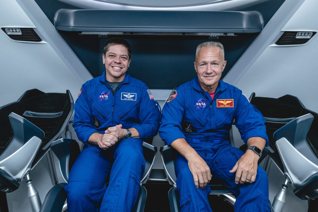 NASA astronauts, from left, Bob Behnken and Doug Hurley, assigned to fly on SpaceX's Demo-2 test flight of its Crew Dragon, are inside a mockup of the spacecraft at NASA's Johnson Space Center in Houston on Aug. 2, 2018