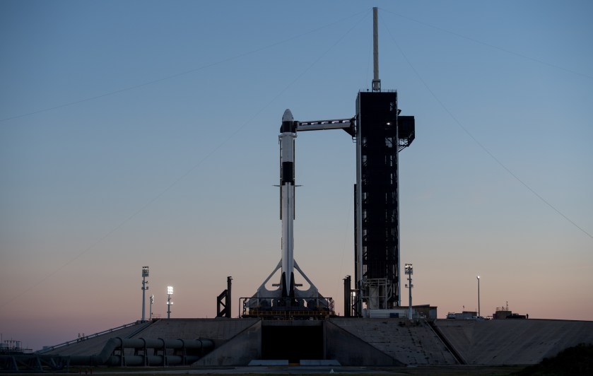 A SpaceX Falcon 9 rocket with the company's Crew Dragon spacecraft onboard is seen after being raised into a vertical position on the launch pad at Launch Complex 39A as preparations continue for the Demo-1 mission, Feb. 28, 2019, at NASA's Kennedy Space Center in Florida.