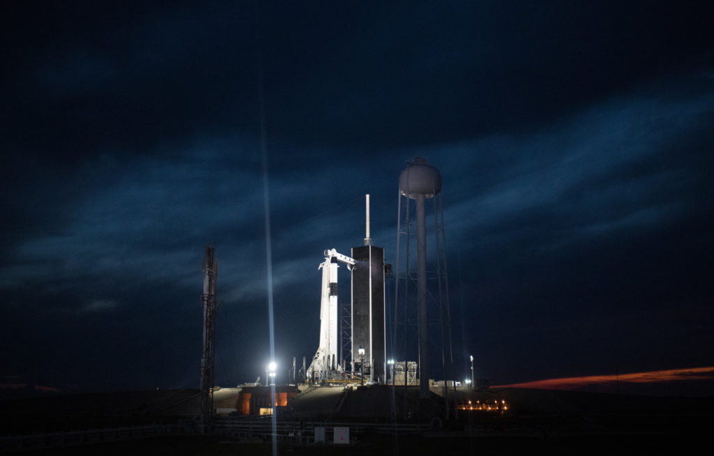 A SpaceX Falcon 9 rocket with the company's Crew Dragon spacecraft onboard is seen illuminated on the launch pad by spotlights at Launch Complex 39A as preparations continue for the Demo-1 mission, Friday, March 1, 2019, at the Kennedy Space Center in Florida.