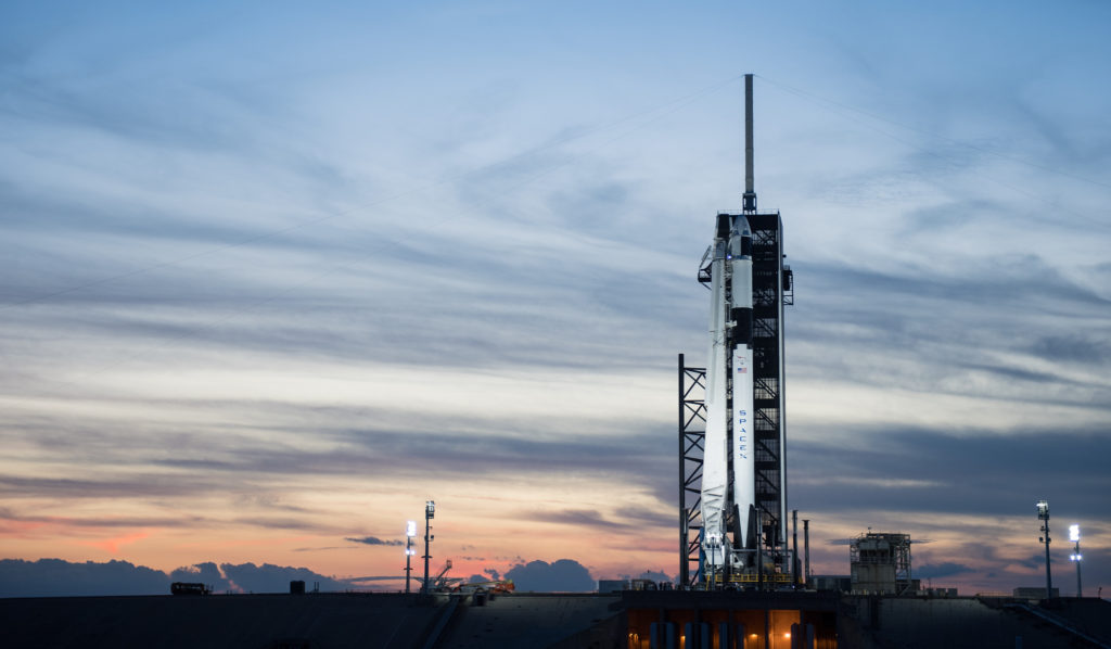 A SpaceX Falcon 9 rocket with the company's Crew Dragon spacecraft onboard is seen after being raised into a vertical position on the launch pad at Launch Complex 39A as preparations continue for the Demo-1 mission, Feb. 28, 2019, at NASA's Kennedy Space Center in Florida.