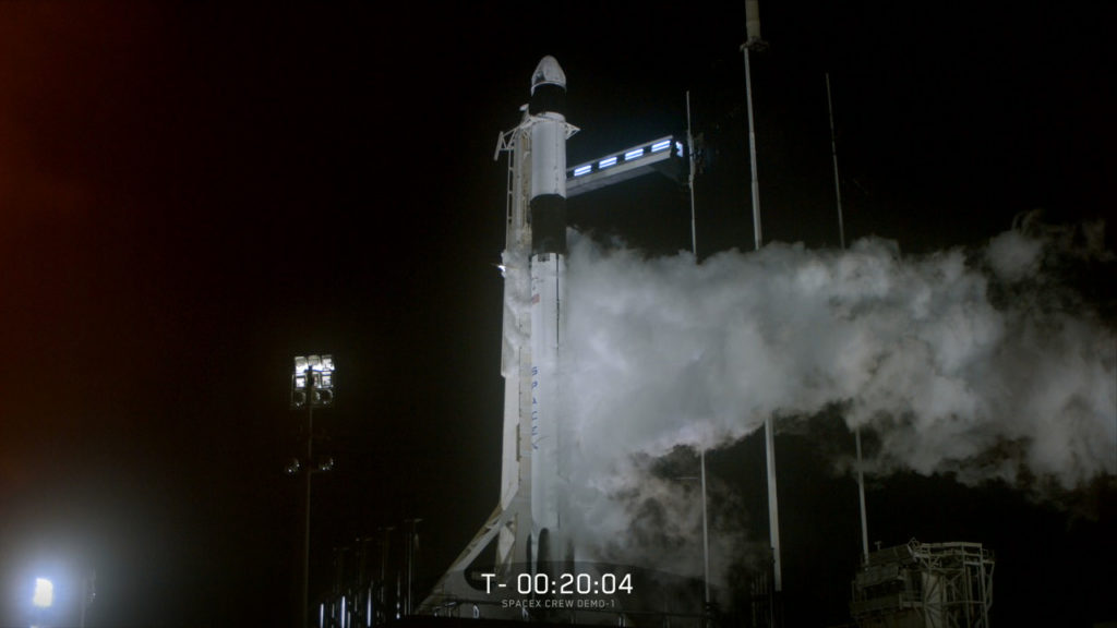 The SpaceX Falcon 9 rocket, topped by the company's Crew Dragon spacecraft, stands on the launch pad at Kennedy Space Center's Launch Complex 39A.