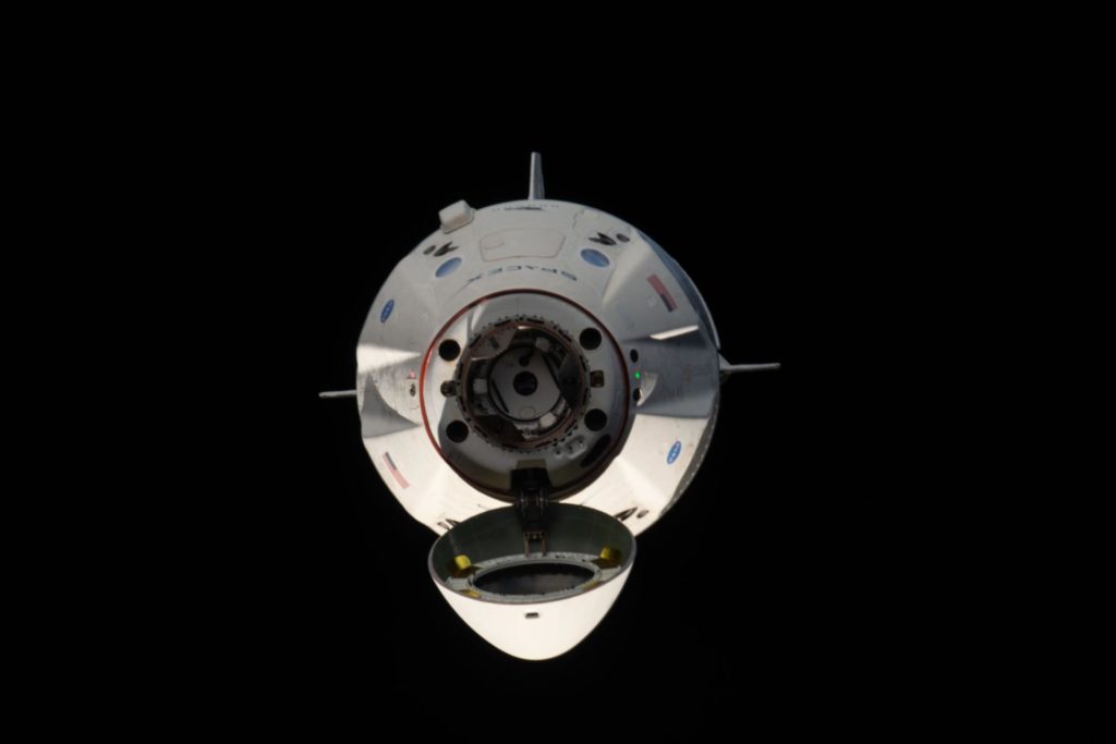 The uncrewed SpaceX Crew Dragon spacecraft s pictured with its nose cone open revealing its docking mechanism while approaching the International Space Station's Harmony module on March 3, 2019.