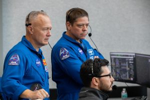 NASA astronauts Doug Hurley, left, and Bob Behnken watch the liftoff of a SpaceX Falcon 9 rocket and Crew Dragon spacecraft on the uncrewed In-Flight Abort Test, Jan. 19, 2020, inside Firing Room 4 in Kennedy Space Center’s Launch Control Center.