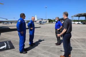 Demo-2 crew members Robert Behnken (far left) and Douglas Hurley are greeted by NASA Administrator Jim Bridenstine (far right) Kennedy Space Center Director Bob Cabana at the Launch and Landing Facility runway.