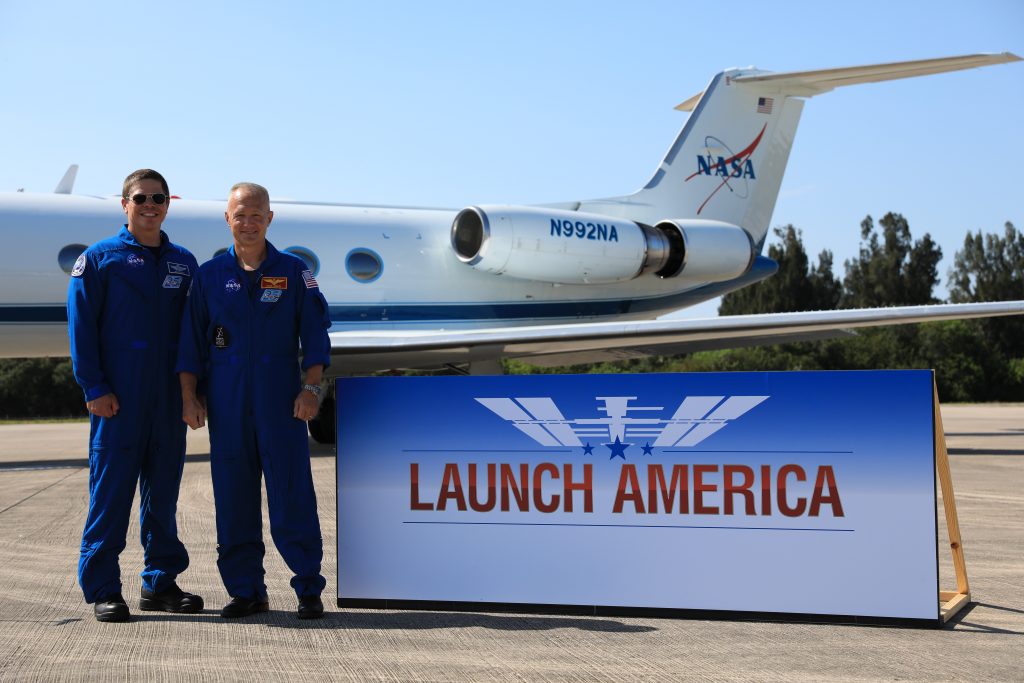 From left, Demo-2 crew members Robert Behnken and Douglas Hurley pose for a photo after speaking to members of the media on May 20, 2020, at the Launch and Landing Facility runway following the crew’s arrival to the Florida spaceport. 