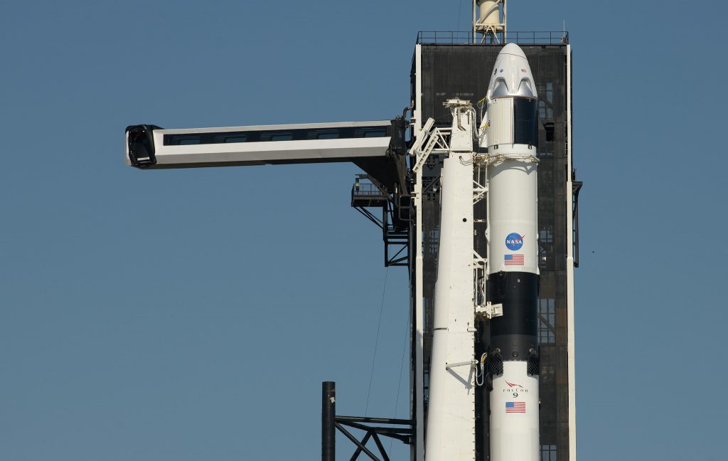 The crew access arm is swung into position for the Crew Dragon spacecraft and the SpaceX Falcon 9 rocket at Launch Complex 39A as preparations continue for the Demo-2 mission, Thursday, May 21, 2020, at NASA’s Kennedy Space Center in Florida.