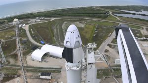 The crew access arm, at right, moves away from the SpaceX Crew Dragon spacecraft. 