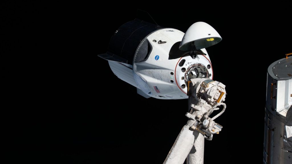 The uncrewed SpaceX Crew Dragon spacecraft became the first Commercial Crew vehicle to visit the International Space Station in March 2019 during NASA's SpaceX Demo-1 mission. Here it is pictured on March 3, 2019, with its nose cone open to reveal its docking mechanism while approaching the station's Harmony module.