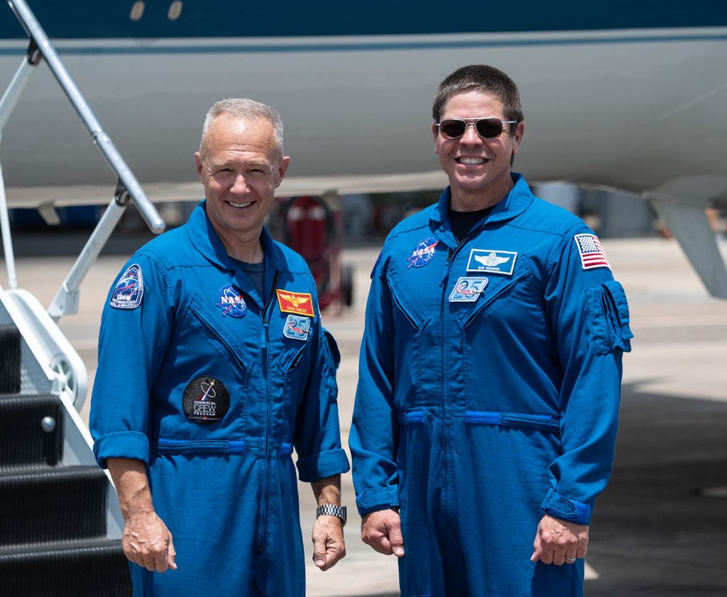 At Ellington Field near NASA’s Johnson Space Center in Houston, astronauts Douglas Hurley (left) and Robert Behnken pose for a photo before boarding the Gulfstream jet that will carry them to the agency’s Kennedy Space Center in Florida on May 20, 2020, in preparation for NASA’s SpaceX Demo-2 mission. Photo credit: NASA/James Blair