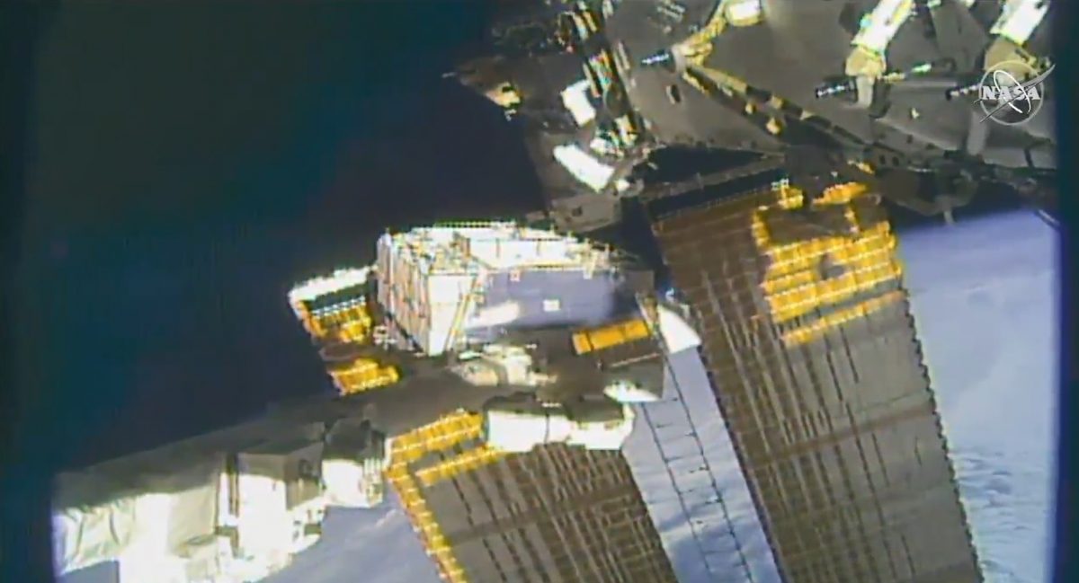 NASA astronaut pictured tethered on the space station's truss structure during a spacewalk to swap batteries and route cables.