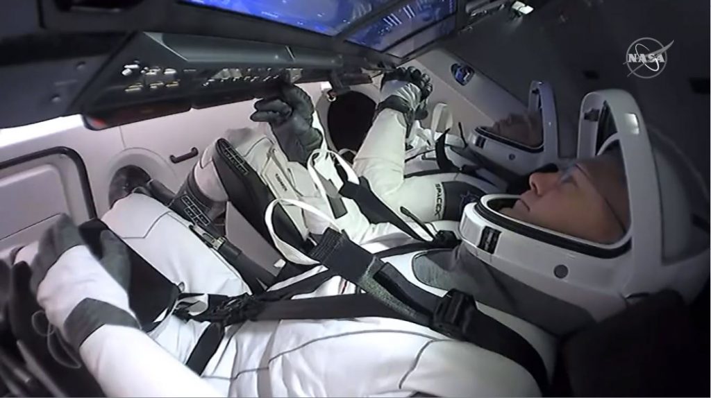 NASA astronauts Douglas Hurley, foreground, and Robert Behnken inside the SpaceX Crew Dragon “Endeavor” spacecraft.