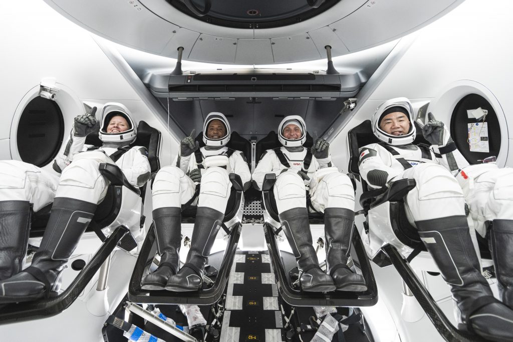 NASA’s SpaceX Crew-1 crew members are seen seated in the company’s Crew Dragon spacecraft during training. From left to right are NASA astronauts Shannon Walker, Victor Oliver, and Mike Hopkins, and JAXA astronaut Soichi Noguchi. Photo credit: SpaceX