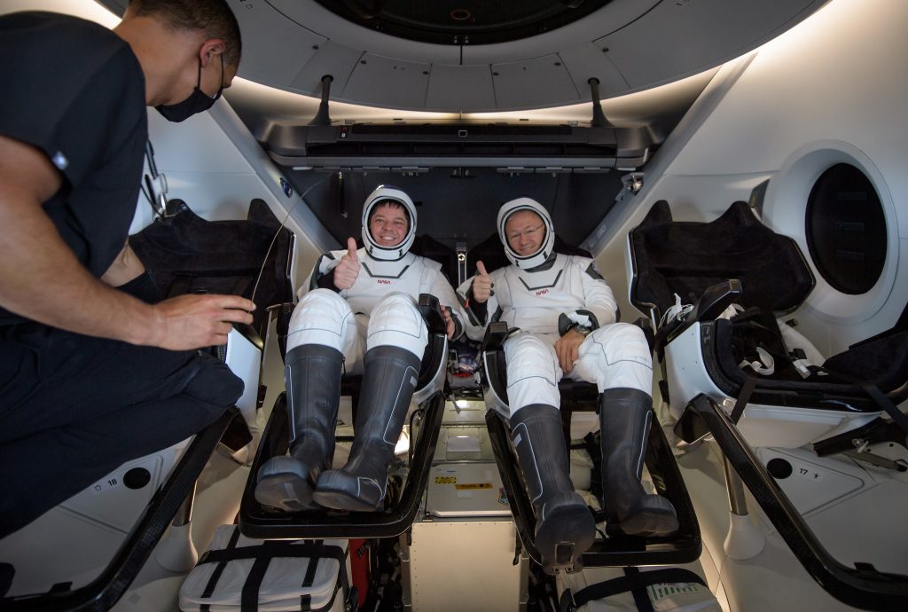 NASA astronauts Robert Behnken, left, and Douglas Hurley are seen inside the SpaceX Crew Dragon Endeavour spacecraft onboard the SpaceX GO Navigator recovery ship shortly after having landed in the Gulf of Mexico off the coast of Pensacola, Florida, Sunday, Aug. 2, 2020.