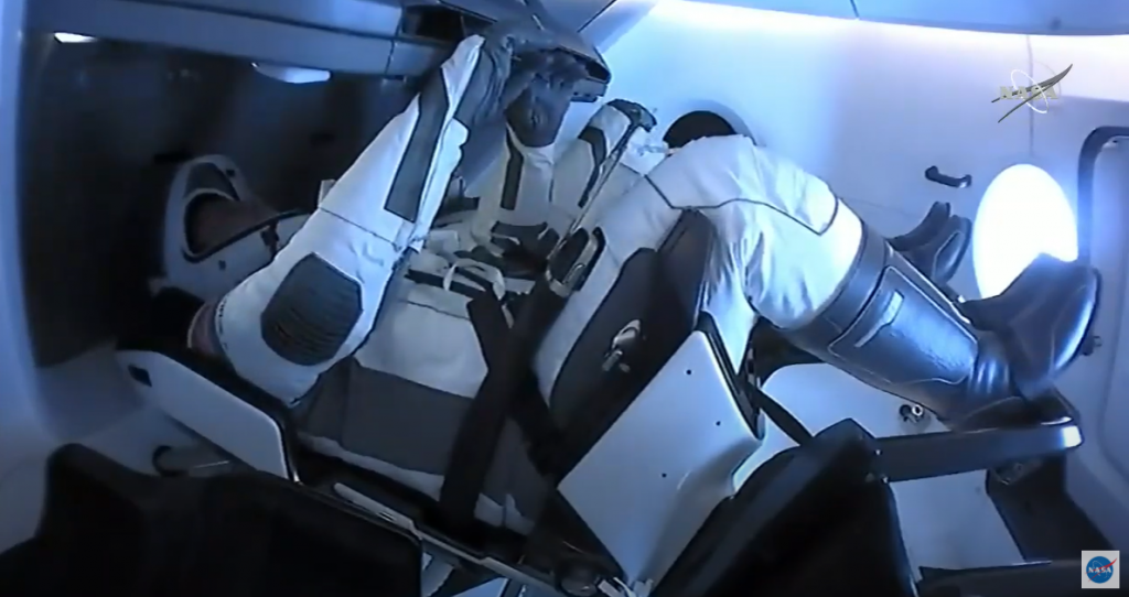 NASA astronauts Robert Behnken and Douglas Hurley are seated inside the SpaceX Crew Dragon spacecraft on Aug. 1, 2020.