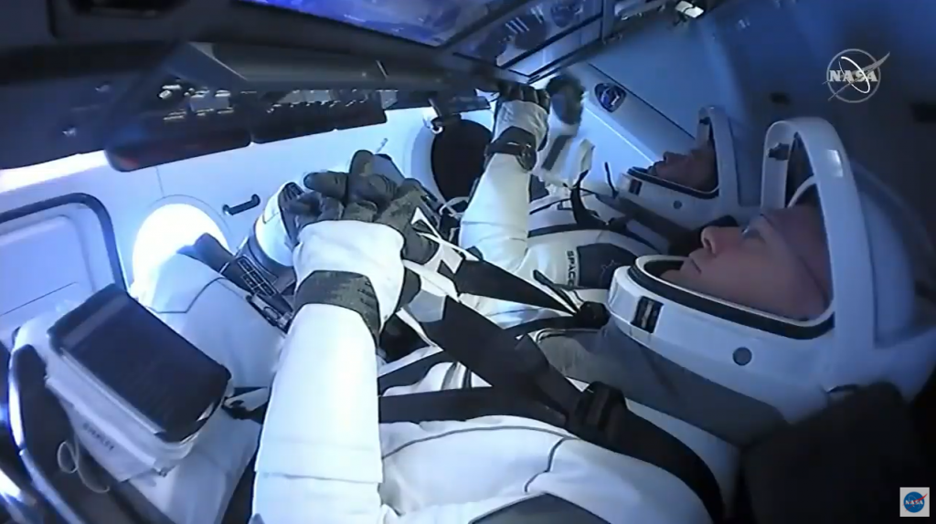 NASA astronauts Douglas Hurley, foreground, and Robert Behnken inside the SpaceX Crew Dragon “Endeavor” spacecraft.