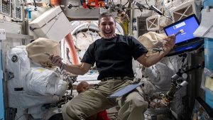 Crew-1 Commander Michael Hopkins works inside the Quest airlock.