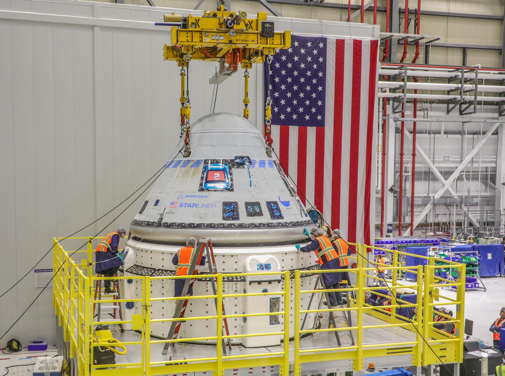 The Starliner team works to finalize the mate of the crew module and new service module for NASA's Boeing Crew Flight Test that will take NASA astronauts Barry “Butch” Wilmore and Sunita “Suni” Williams to and from the International Space Station.