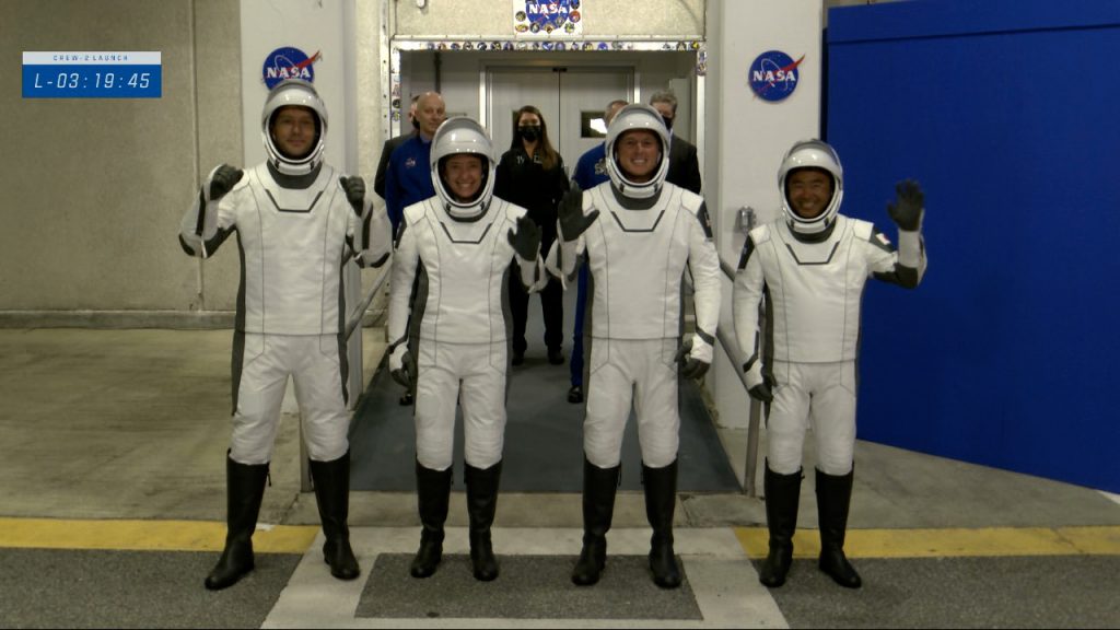 The Crew-2 astronauts walk out the double doors to board their Tesla's for the ride to Launch Complex 39A on April 23, 2021