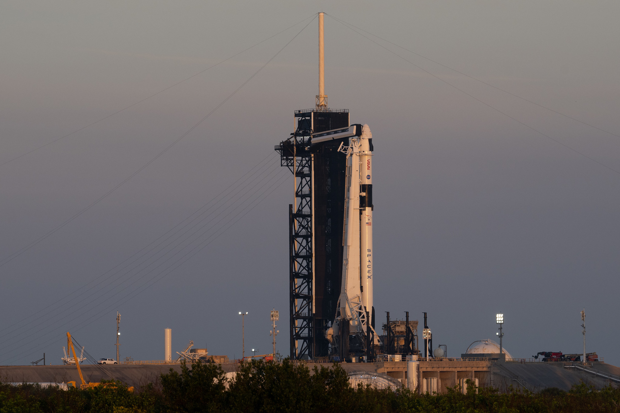 Falcon 9 rocket and Dragon Endeavour spacecraft raised to the vertical position at Kennedy Space Center's Launch Complex 30A