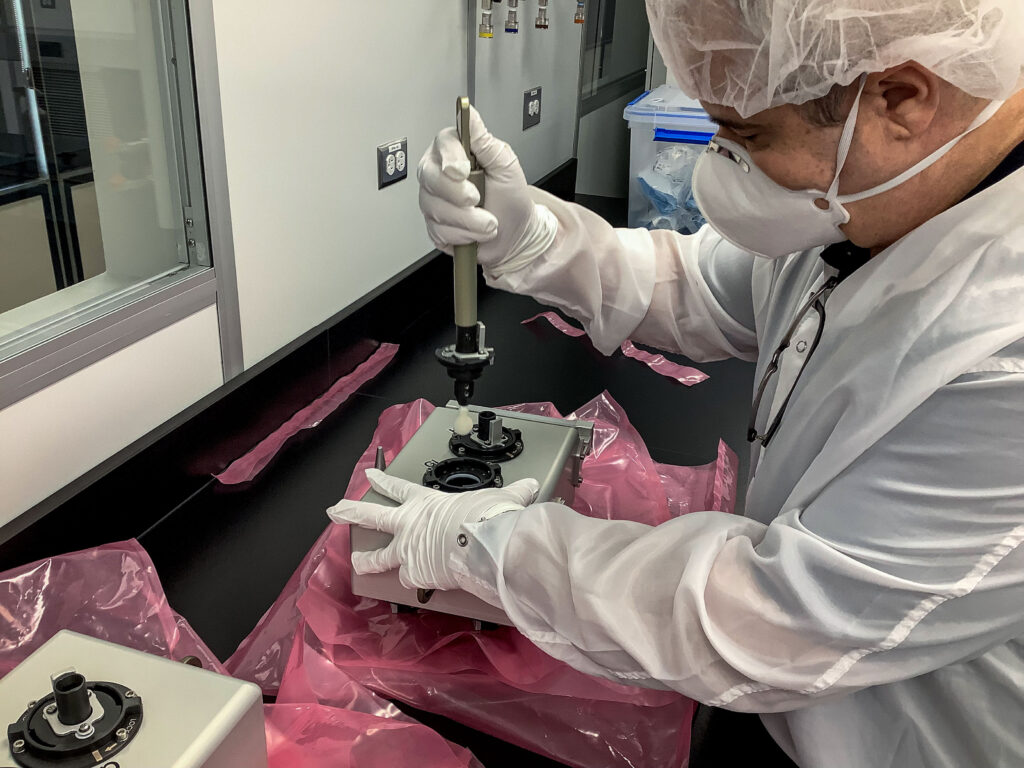 A member of the International Space Station External Microorganisms payload development team demonstrates removing a swab from the sampling caddy that is used by an astronaut during a spacewalk. A crew member uses the swabbing tool to collect samples from the exterior surface of the space station at various locations as part of a study to examine whether a spacecraft releases microorganisms and, if so, how many and how far they may travel. Results could inform preparations for future human exploration missions to the Moon and Mars. 