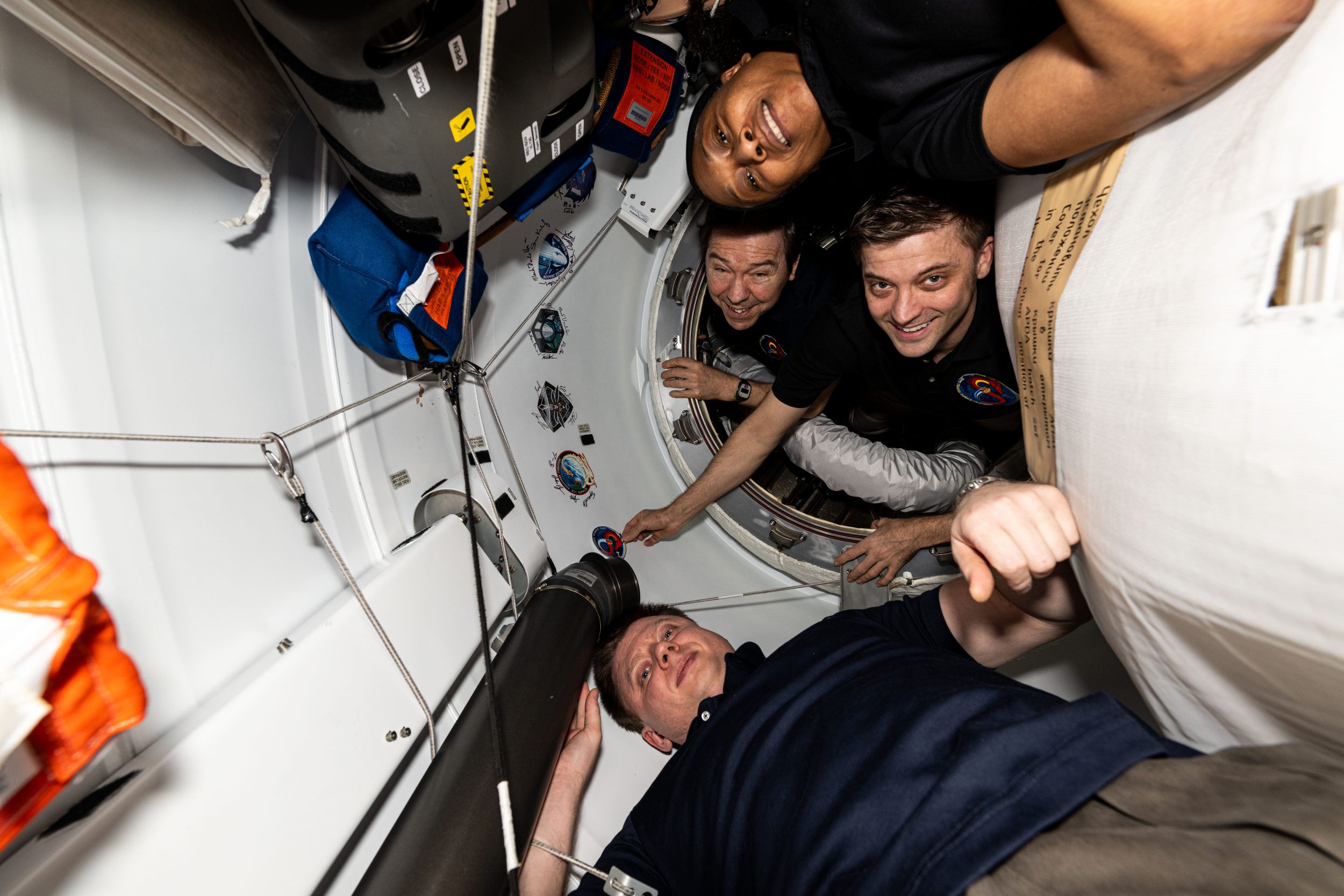 The four crew members that make up the SpaceX Crew-8 mission aboard the International Space Station are pictured in the vestibule in between the Harmony module's space-facing port and the SpaceX Dragon Endeavour spacecraft. From top to bottom are, NASA astronauts Jeanette Epps, Mike Barratt, and Matthew Dominick, and Roscosmos cosmonaut Alexander Grebenkin.