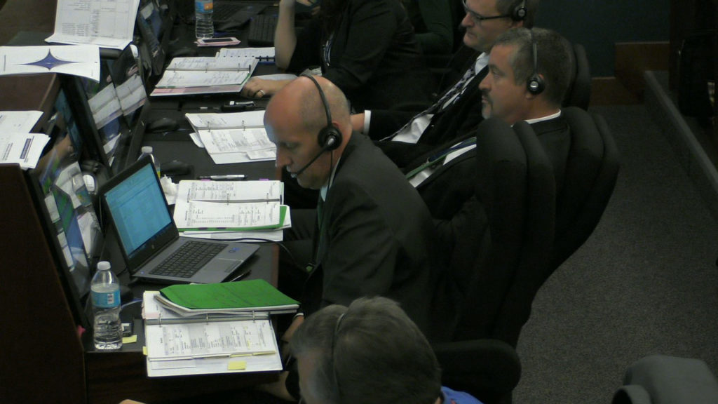 NASA Launch Manager Tim Dunn, center, on console in the Mission Director's Center. 