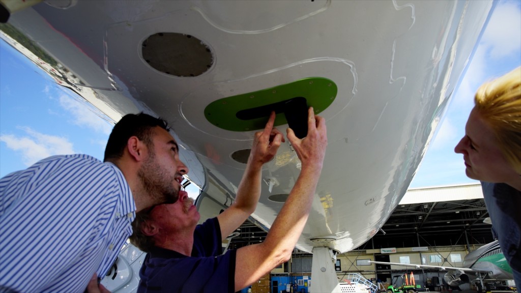 Scientists examine an aircraft instrument.