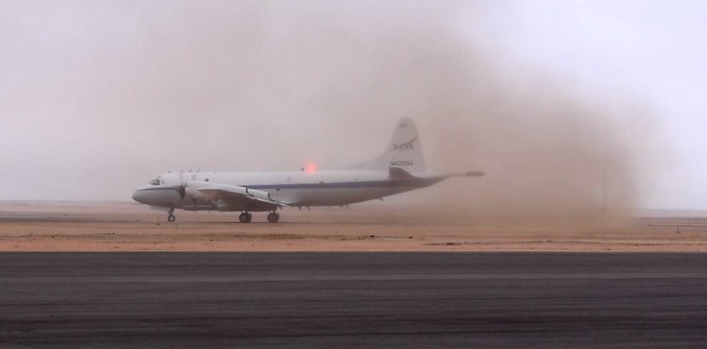 A cloud of fine sand billows up as the P-3 moved down the runway at the Walvis Bay Airport. Credit: NASA/Jane Peterson