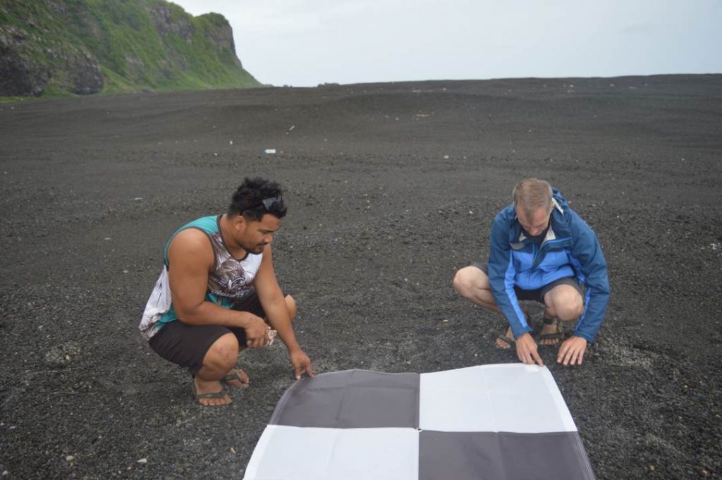 Dan Slayback (right) and Pen Vailea (left) placing down drone/satellite target. 