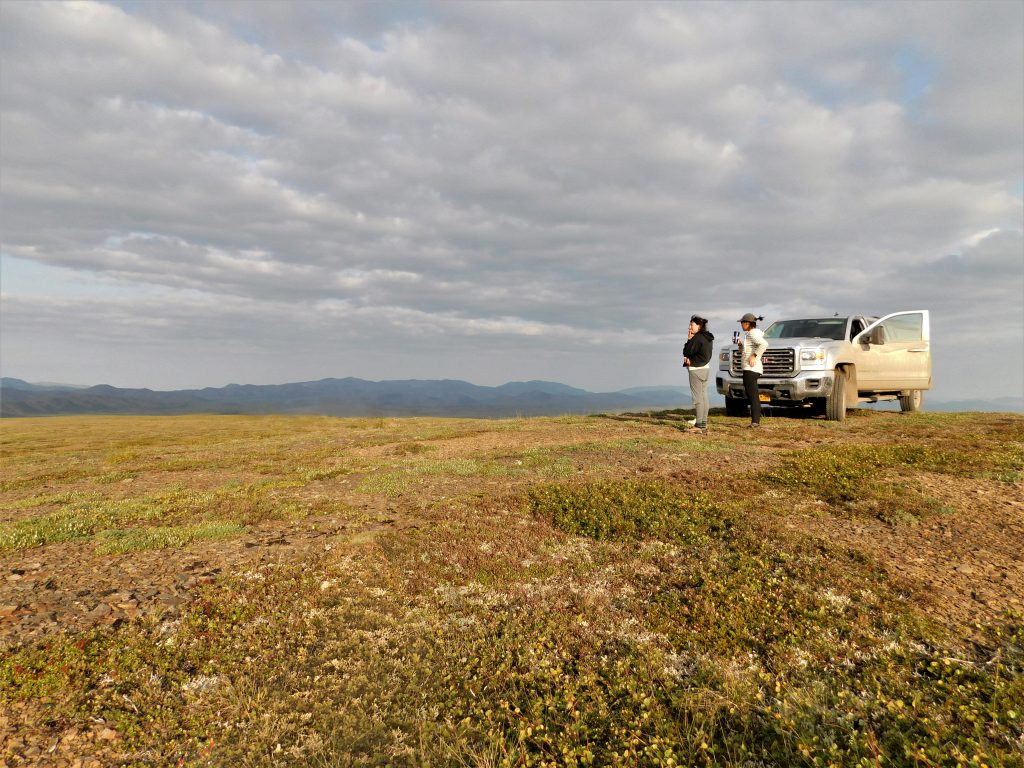 Rachel (left) and Kayla Arey (right) soak in our first caribou sighting as summer winds down in the Arctic. Photo credit: Laurence Carter