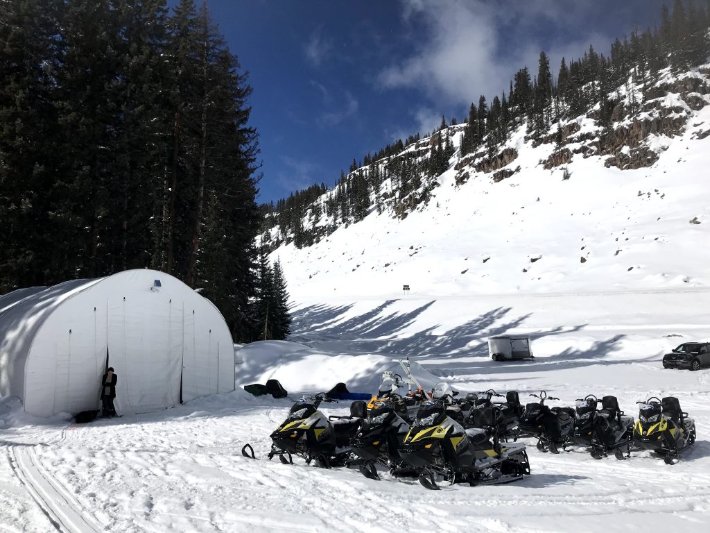 The SnowEx team reached the field sites via daily snowmobile trips. The ride is bumpy and can take 45 minutes to 2 hours, depending on where they’re working on the mesa. They towed their instruments and gear on sleds behind the snowmobiles. Credit: NASA / Jessica Merzdorf