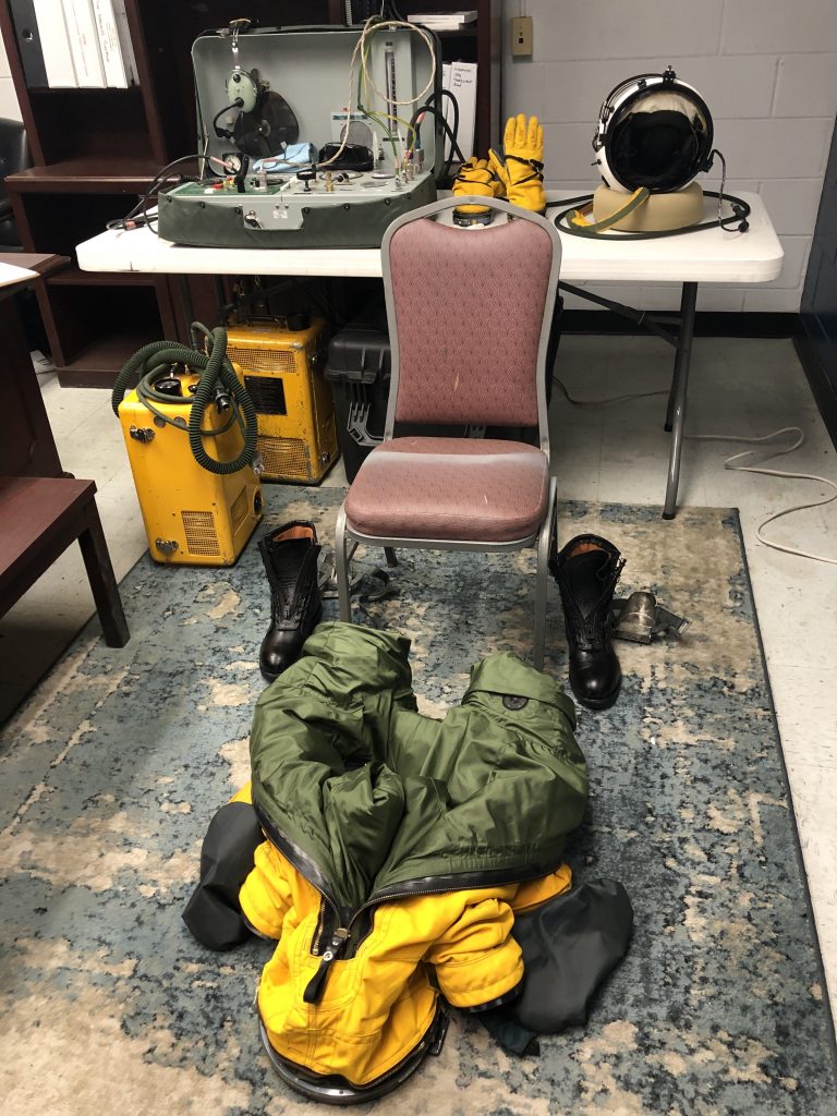 Prior to every flight, the ER-2 Life Support team lays out all of the equipment to aid in an easier suiting up process. The suits weigh between 35-40 pounds and every pilot wears long underwear inside the suit. It is important to make sure that the pilot does not overheat during the suiting process so the pilots are usually assisted by a Life Support crew member. Credit: NASA/Katie Stern