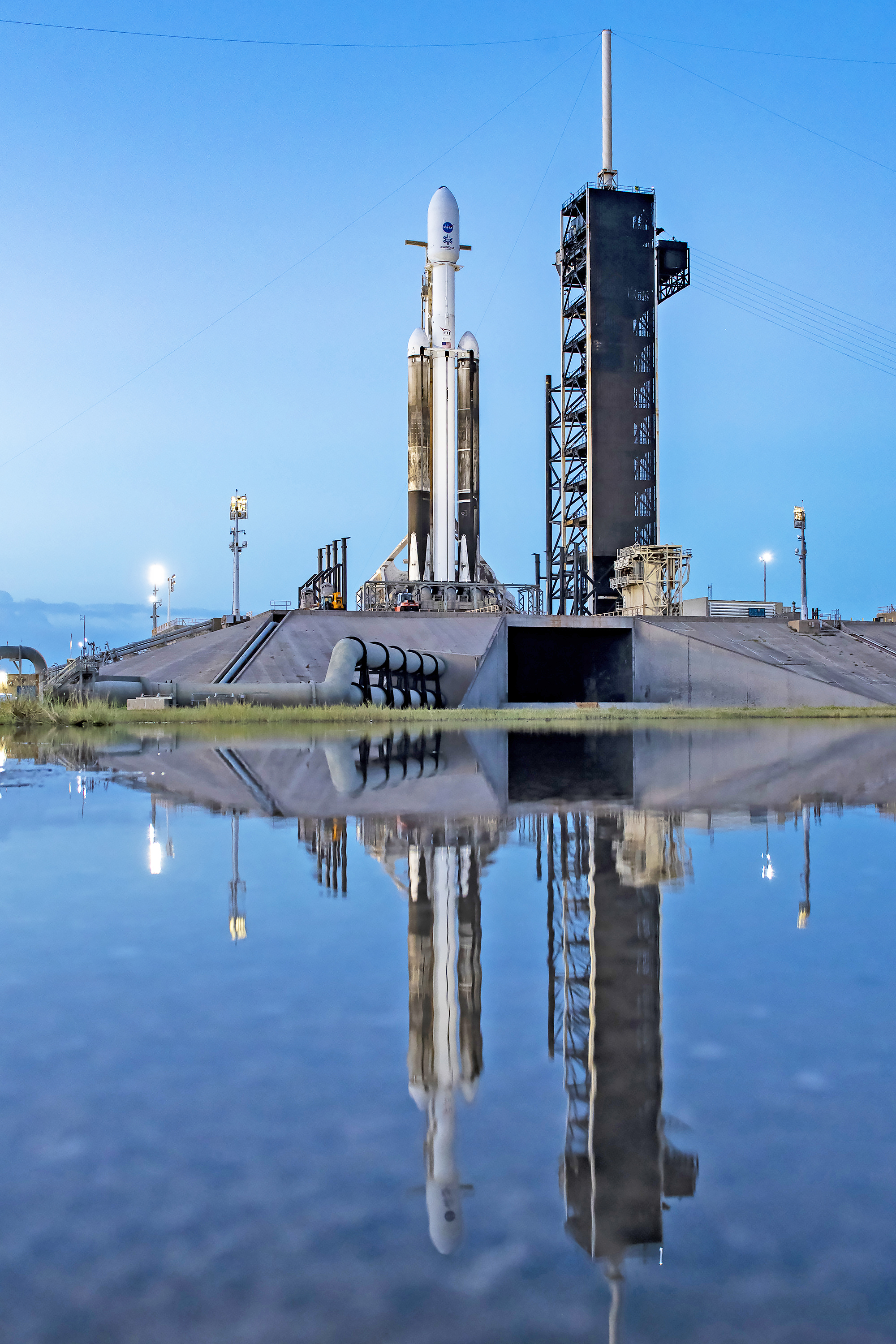 NASA’s Europa Clipper spacecraft and SpaceX’s Falcon Heavy rocket stands at Launch Pad 39A on Sunday, Oct. 13, 2024, at the agency’s Kennedy Space Center in Florida ahead of launch to Jupiter’s icy moon, Europa. The spacecraft will complete nearly 50 flybys of Europa to determine if there are conditions suitable for life beyond Earth. Europa Clipper’s launch period opens at 12:06 p.m. EDT on Monday, Oct. 14, from Launch Complex 39A at Kennedy Space Center in Florida.