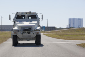 NASCAR Driver Carl Edwards drives MRAP around Pad 39B perimeter and visits the VAB.